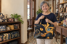 Mei Ling holding a Mystic Cat quilted bag in a Singapore bag shop